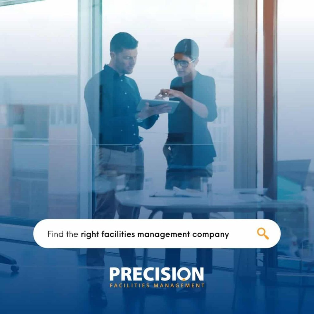 a man and woman standing in front of a window and discuss about the professional facility maintenance company