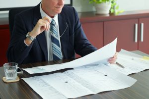 CEO reviewing Building Safety Act 2022 compliance documentation for high rise building portfolio