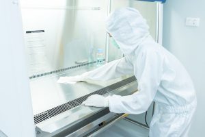Technician maintaining laboratory equipment for GMP